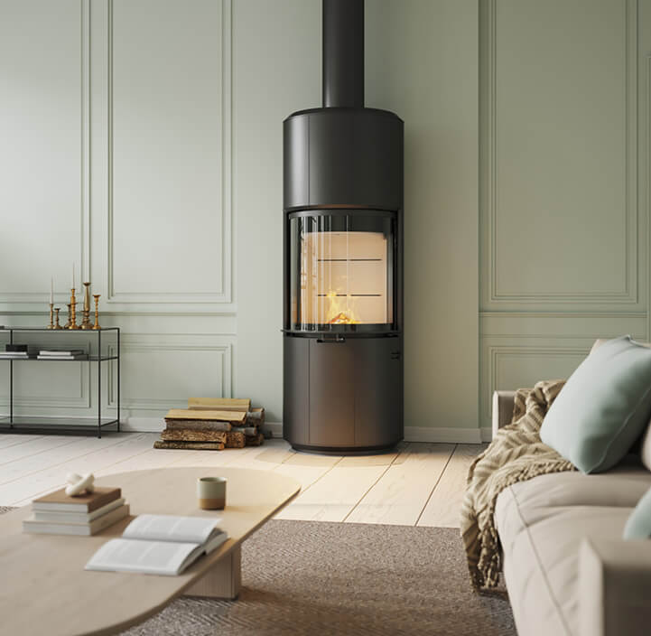 Large black wood stove Scan 87 Floor in green room with light brown sofa and light oak table